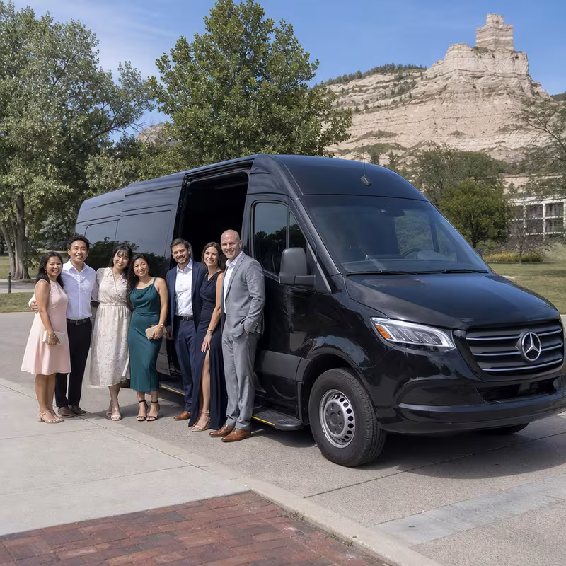Group beside a Mercedes Sprinter limo from the Lincoln fleet