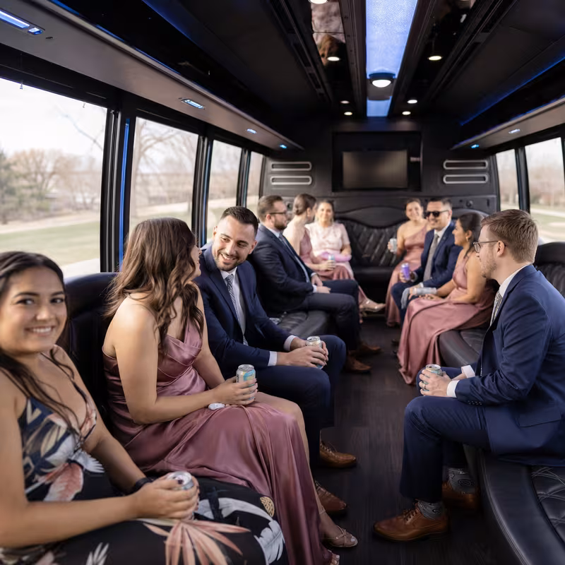 Wedding guests seated inside a Lincoln party bus