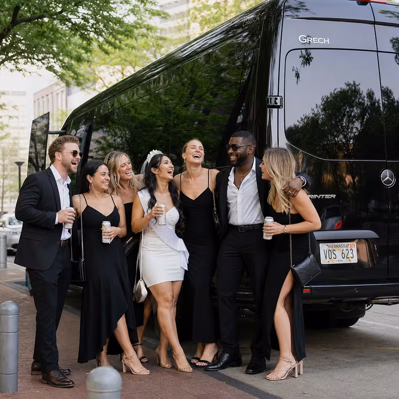 Group boarding a white charter bus for Bachelor & Bachelorette Transportation transportation in Lincoln