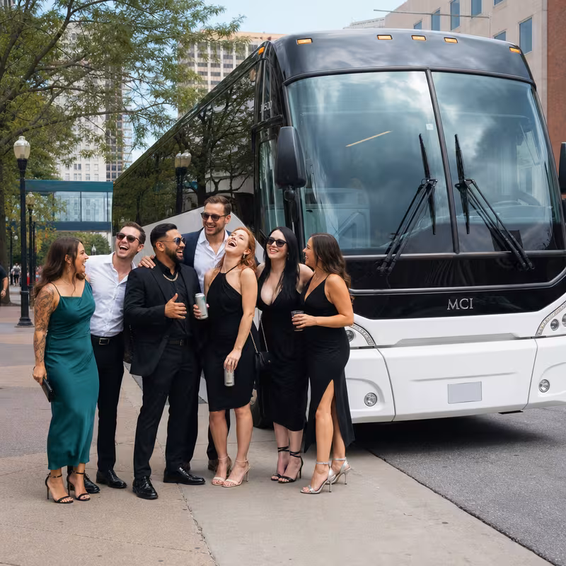 Passengers loading luggage while boarding an Lincoln group shuttle