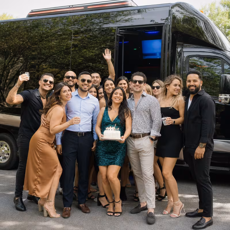 Group boarding a white charter bus for Birthday Transportation transportation in Lincoln