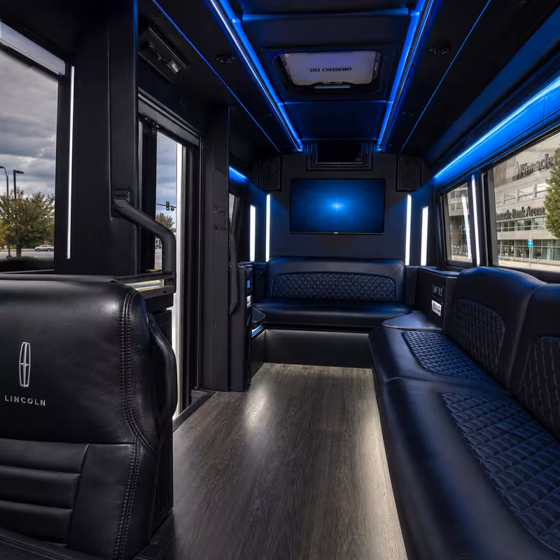 Party bus interior with wraparound leather seating and LED lighting in Lincoln