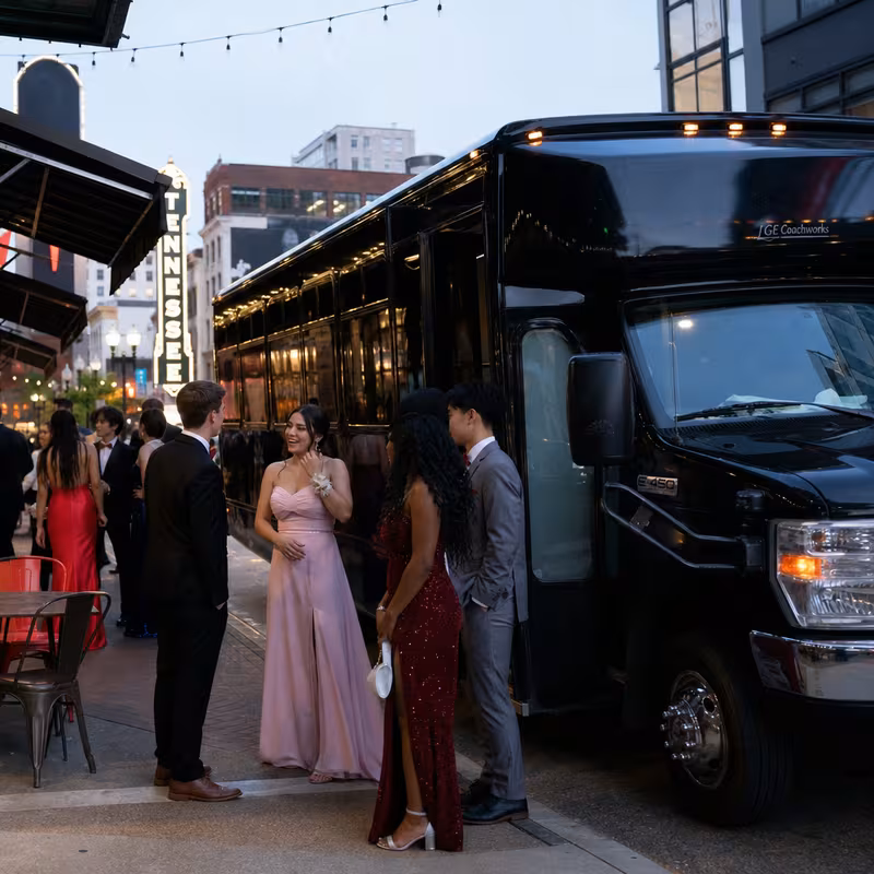 Passengers loading luggage while boarding an Lincoln group shuttle
