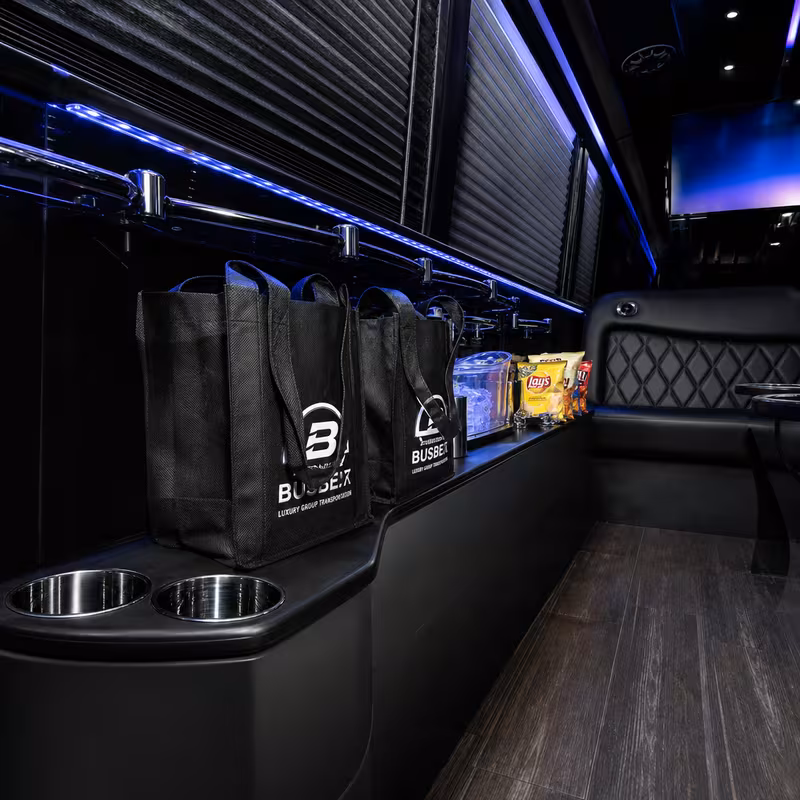 Party bus interior with wraparound leather seating and LED lighting in Lincoln