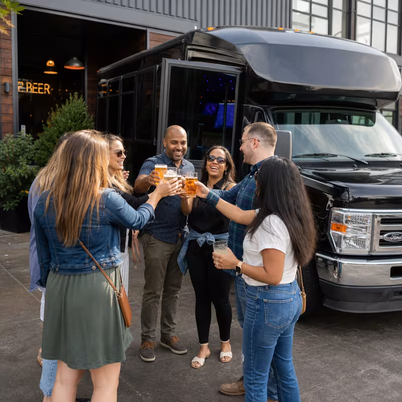 Passengers loading luggage while boarding an Lincoln group shuttle